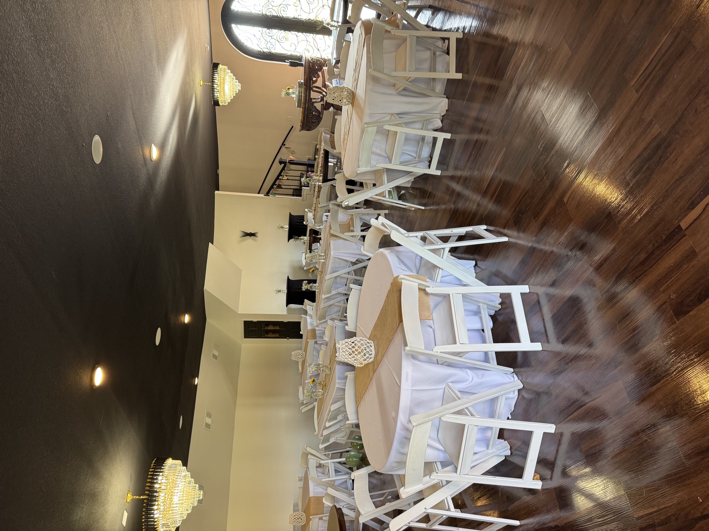 Reception tables beneath crystal chandeliers